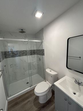 Lakeland apartment for rent - A white toilet sits next to a sink in a bathroom.
