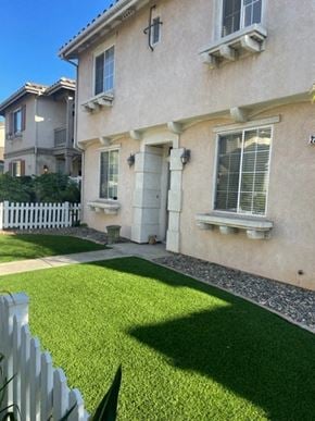 Santa Maria house for rent - A house with a white picket fence and a green lawn.
