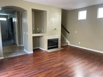Santa Maria house for rent - A living room with a fireplace and wood flooring.