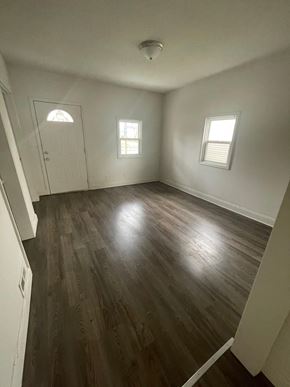 Lima house for rent - an empty living room with hardwood floors and white walls