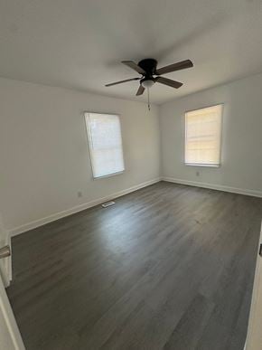 Fayetteville apartment for rent - an empty living room with wood floors and a ceiling fan