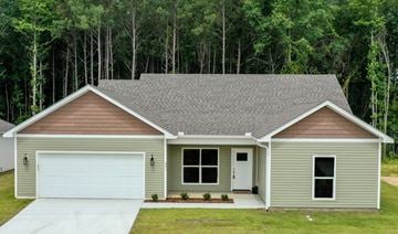 Benton house for rent - a green house with a garage door and a