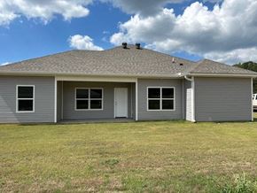 Benton house for rent - a gray house with a yard and a cloudy sky