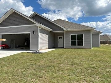 Benton house for rent - a gray house with a yard in front of it
