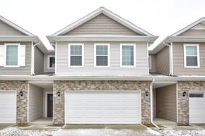 Waukee apartment for rent - A row of houses with garages on the side.