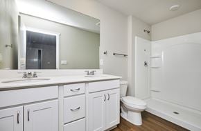 Waukee apartment for rent - A white bathroom with a toilet, sink, and bathtub.