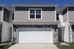 Waukee apartment for rent - A two-story house with a garage door.
