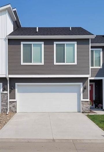 West Des Moines apartment for rent - A grey house with a white garage door.