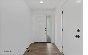 West Des Moines apartment for rent - A white door is in a hallway with wood floors.
