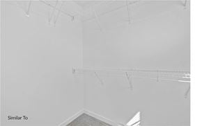 West Des Moines apartment for rent - A white room with a grey carpet and clothes hangers.