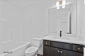 West Des Moines apartment for rent - A white bathroom with a toilet, sink, and mirror.