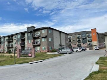 Hickman apartment for rent - a street view of an apartment building with cars parked in front