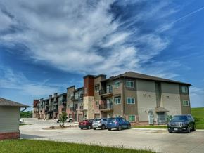 Hickman apartment for rent - Apartment complex with cars parked in front.
