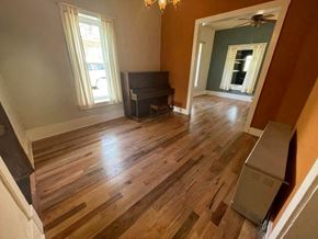 La Veta house for rent - a living room with a hard wood floor and a piano