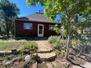 La Veta house for rent - a red house with a stone walkway in front of it