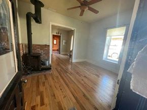 La Veta house for rent - a living room with a wood floor and a fireplace