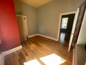 La Veta house for rent - a empty room with wooden floors and a door