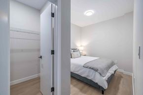 Winnipeg apartment for rent - A bedroom with a bed, pillows, and a nightstand.