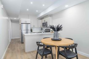 Winnipeg apartment for rent - A kitchen with a table and chairs in the foreground.