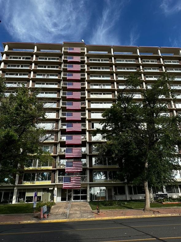 Colorado Springs apartment for rent - an apartment building with the flag displayed in front of it