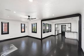 North Hollywood house for rent - a living room with white walls and a dark wood floor