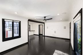 North Hollywood house for rent - an empty living room with white walls and a ceiling fan