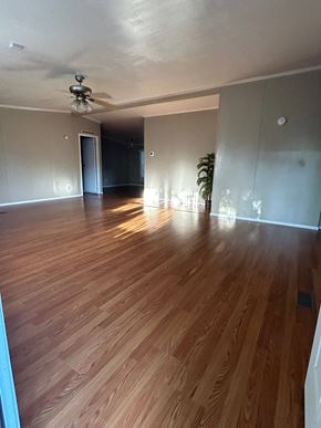 Harker Heights house for rent - an empty living room with wooden floors and a ceiling fan