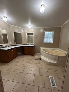 Harker Heights house for rent - a bathroom with a tub and a sink and a mirror