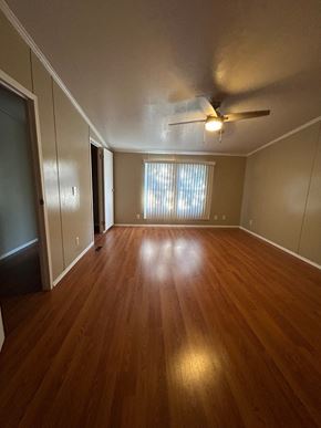 Harker Heights house for rent - an empty living room with wood floors and a ceiling fan