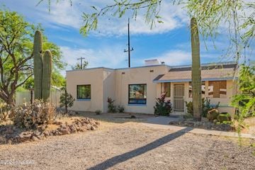 Tucson house for rent - a white house with a cactus and a gravel driveway