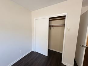 Victoria apartment for rent - A white door is open to a room with a brown shelf.