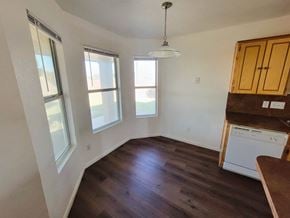 Killeen house for rent - an empty kitchen with hardwood floors and a window