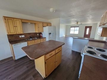Killeen house for rent - a kitchen with wooden cabinets and a stove and a sink