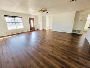 Killeen house for rent - an empty living room with hardwood floors and a ceiling fan