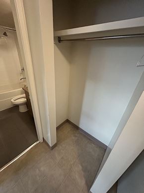 Calgary apartment for rent - a small bathroom with a toilet and a sliding door