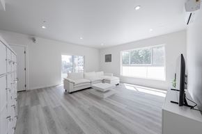 Los Angeles apartment for rent - a white living room with a white couch and a tv