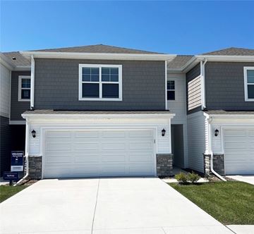 Urbandale apartment for rent - A modern two-story house with a garage door and a driveway.