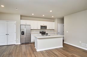 Urbandale apartment for rent - A kitchen with a white island and stainless steel appliances.