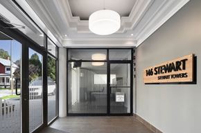 Ottawa apartment for rent - The lobby of a building with a sign that reads "146 STEWART STEWART TOWERS".