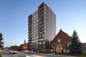 Ottawa apartment for rent - a high rise building next to a church and a street