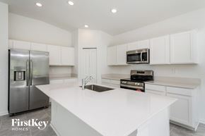 Winter Haven house for rent - a white kitchen with stainless steel appliances and white counter tops