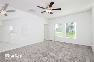 Winter Haven house for rent - a living room with carpet and a ceiling fan