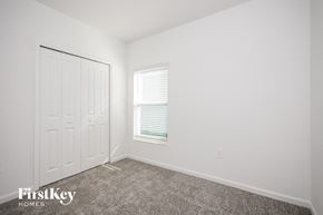 Winter Haven house for rent - a bedroom with white walls and carpet and a white door and window