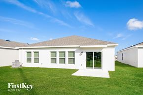Winter Haven house for rent - a white house with green grass and a blue sky