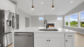 Hudson house for rent - a white kitchen with a sink and a refrigerator