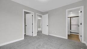 Hudson house for rent - a bedroom with three doors and a carpeted floor