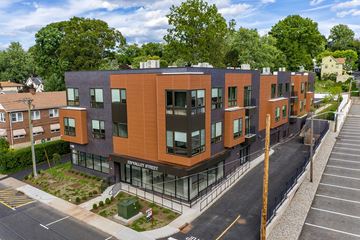 South Orange apartment for rent - A modern apartment building with a parking lot in front.
