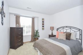 Omaha apartment for rent - a bedroom with a bed and a dresser