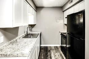 Omaha apartment for rent - a kitchen with black appliances and white counter tops