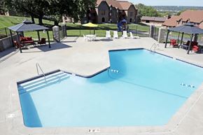 Omaha apartment for rent - an empty swimming pool with tables and umbrellas at a resort
